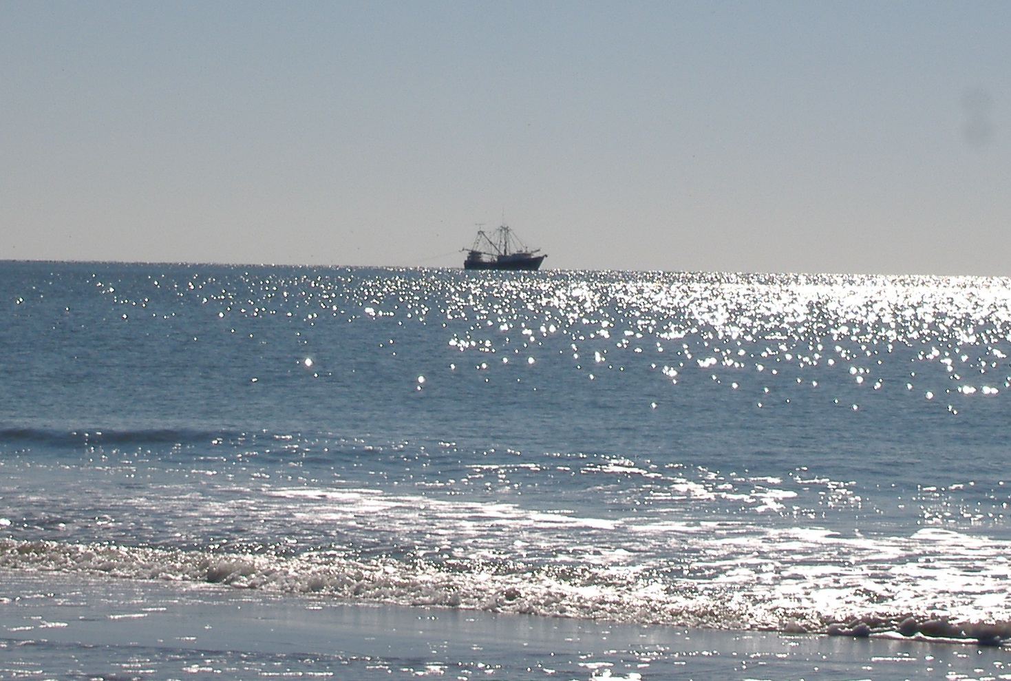 boat on the ocean at Oak Island NC pictures
